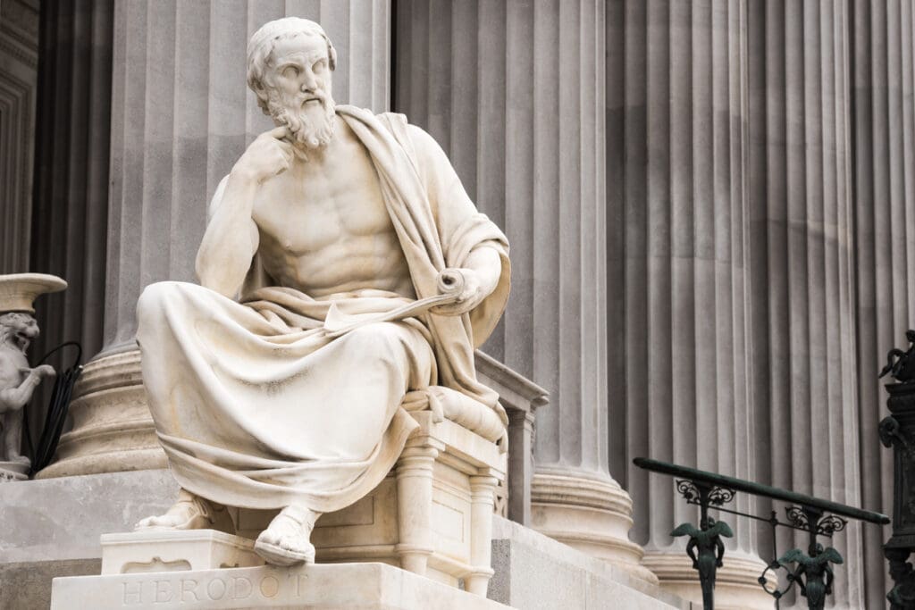 White marble sculpture of Herodotus seated with scroll, symbolizing classical artistry and the enduring legacy of famous marble sculptures.