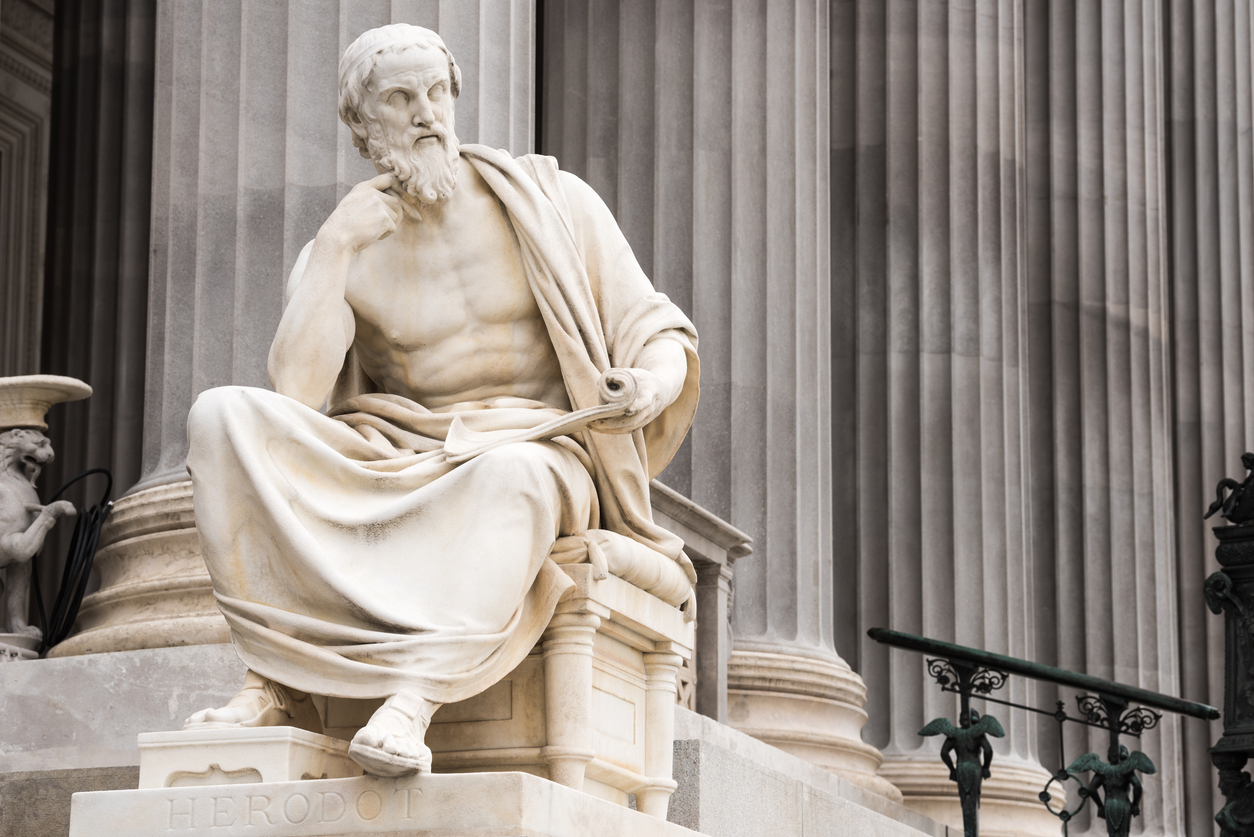White marble sculpture of Herodotus seated with scroll, symbolizing classical artistry and the enduring legacy of famous marble sculptures.