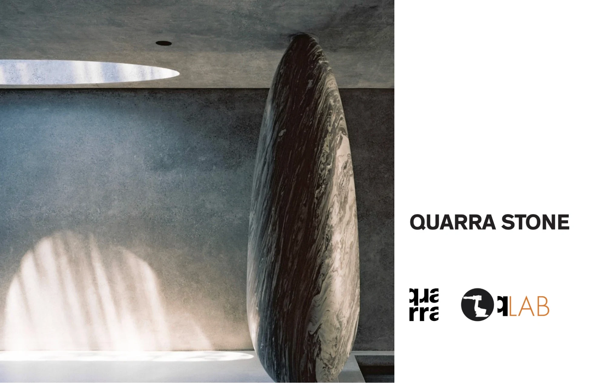 Large, upright oval stone with textured surface stands in a minimalist concrete room, lit by sunlight from a circular ceiling opening. QUARRA STONE and logos appear on the right against a white background.